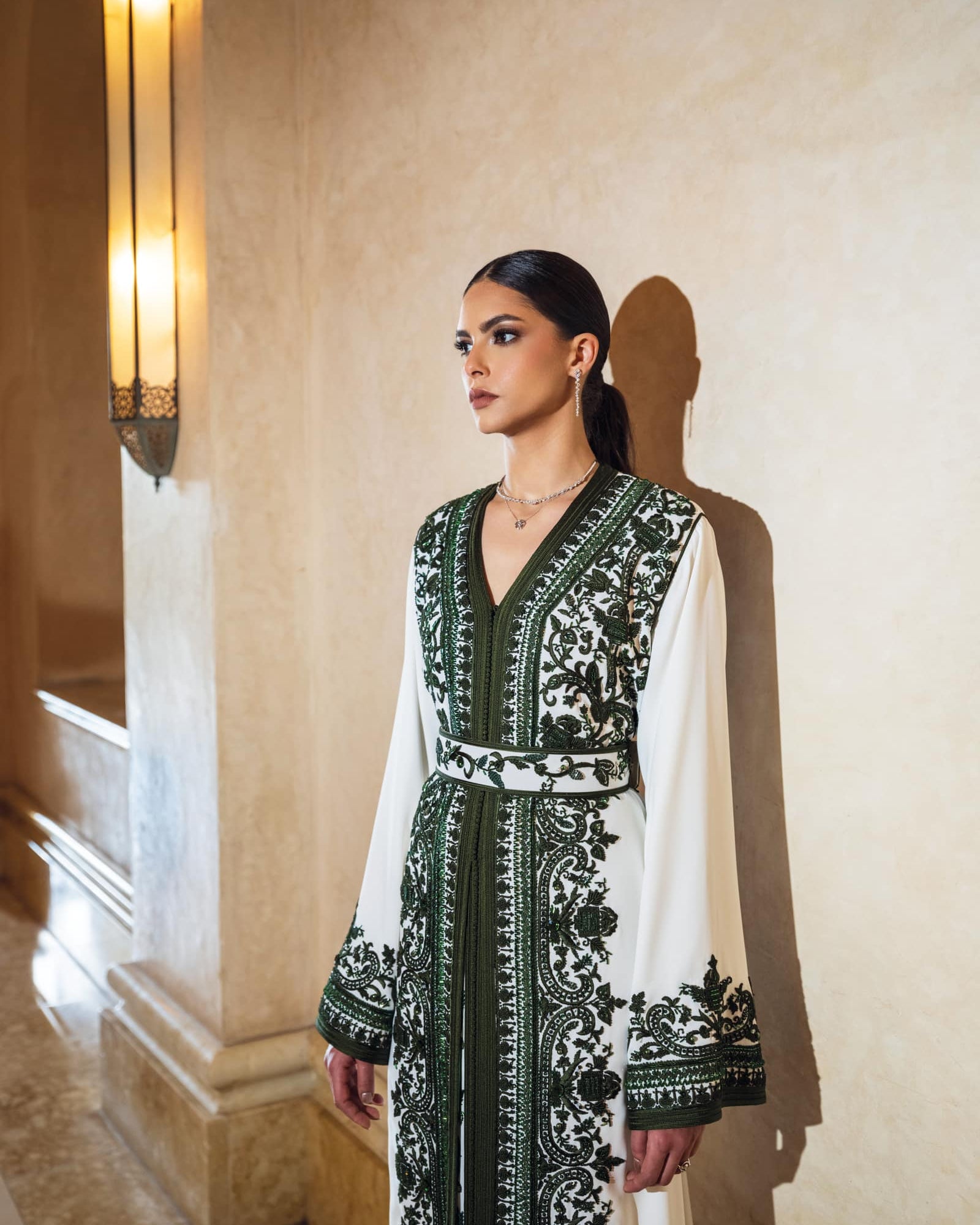 Ivory Moroccan kaftan with deep green embroidery and fluid sleeves