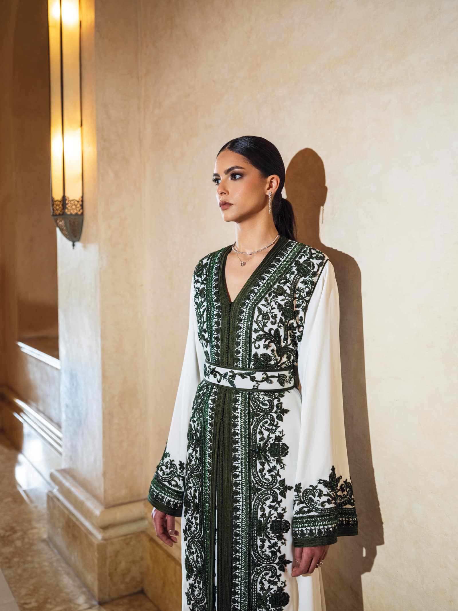 Ivory Moroccan kaftan with deep green embroidery and fluid sleeves
