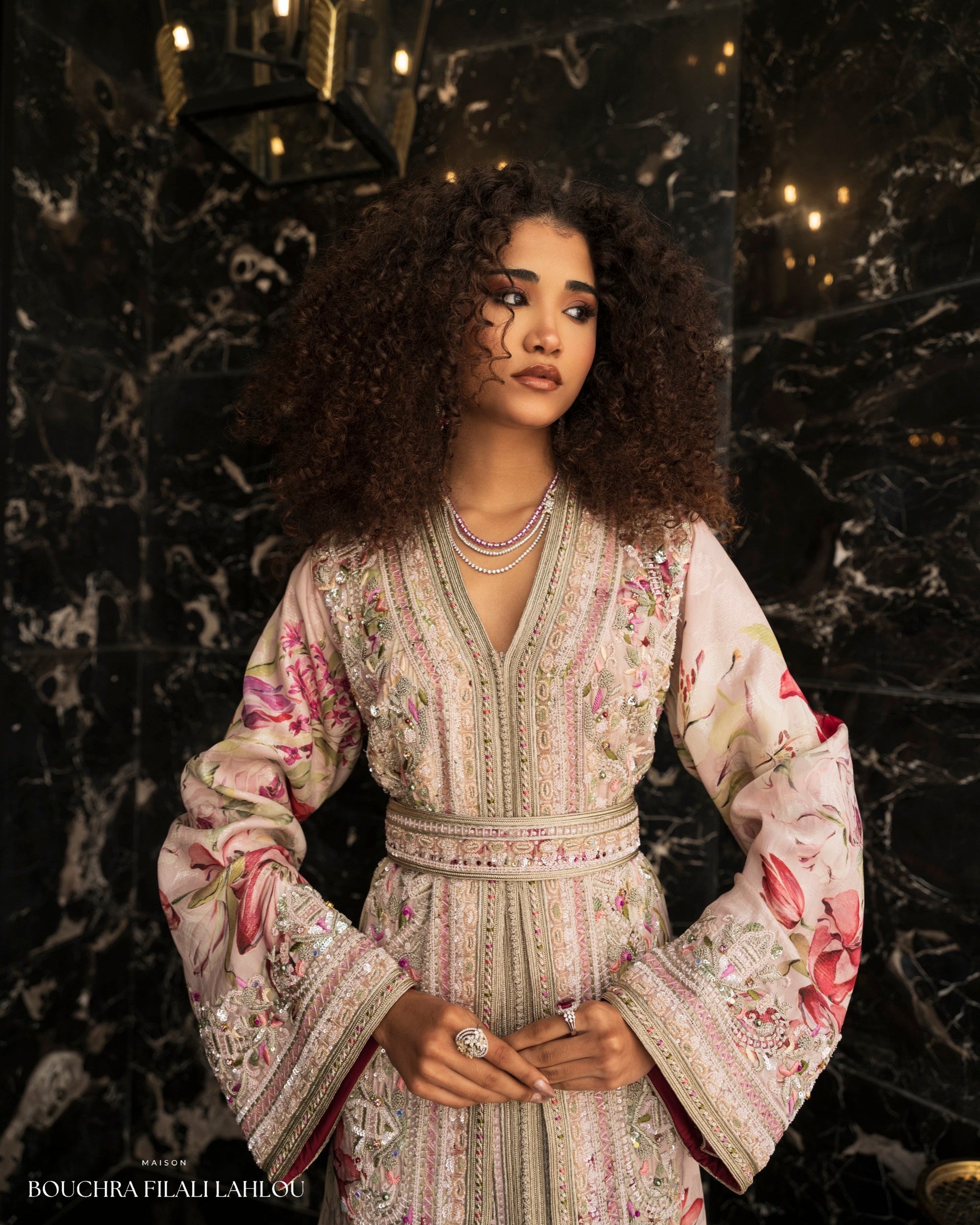 Pale floral Moroccan caftan detail with ornate embroidery and fluid wide sleeves