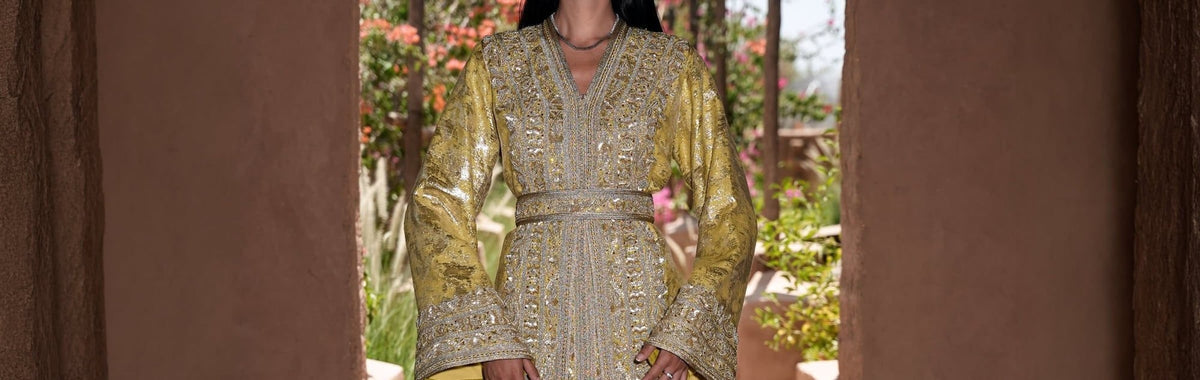 Citron brocade Moroccan kaftan with silver embroidery in a Marrakech garden